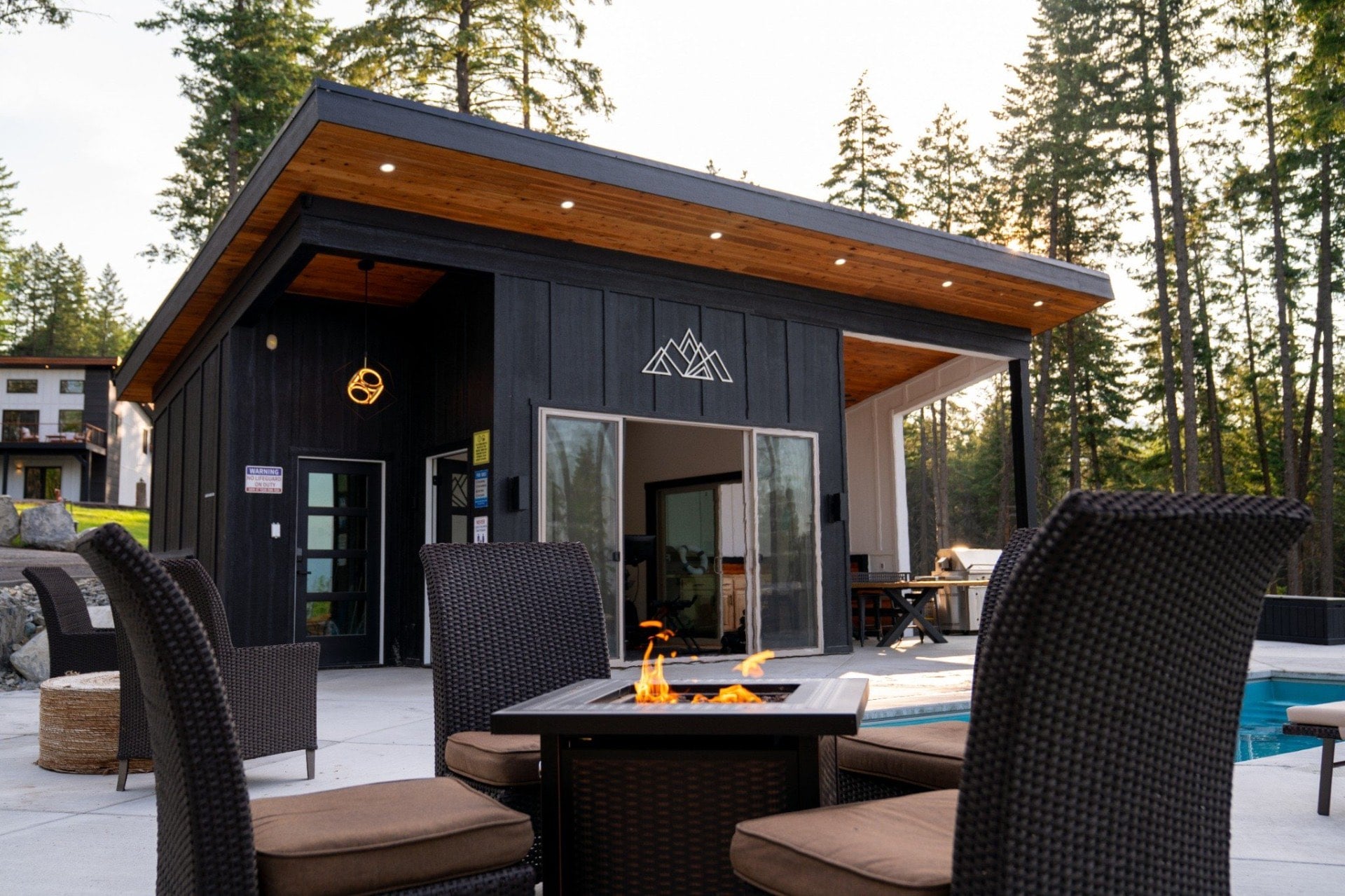The pool house and fire pit at dusk