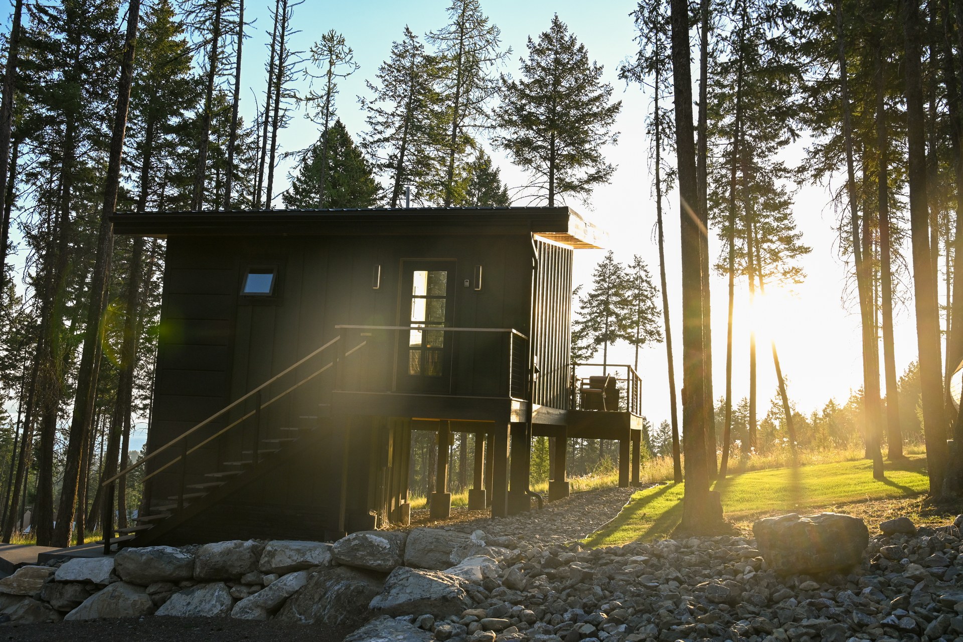 A treehouse at sunset, the light coming through the pines