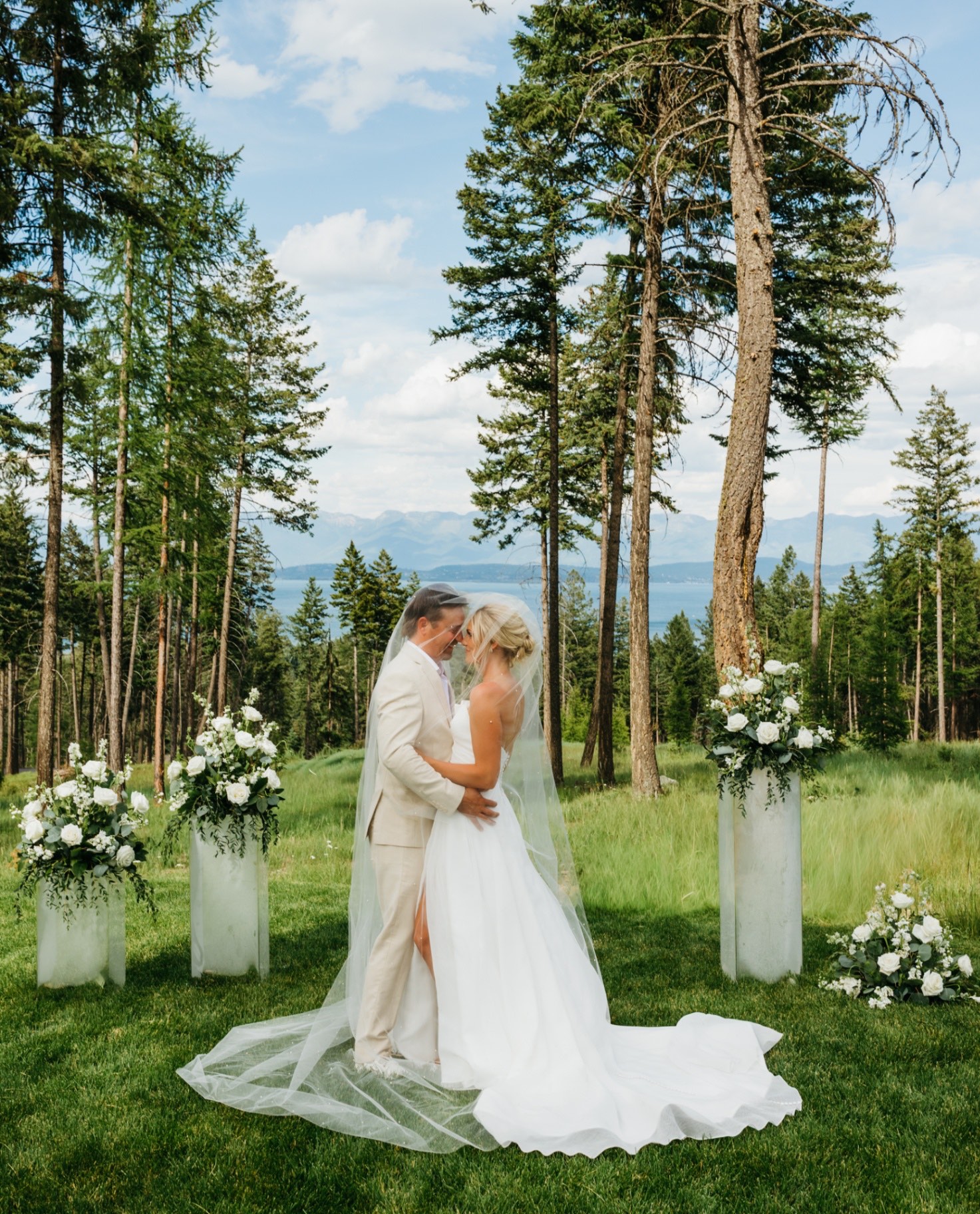 A couple beneath the ceremony arch