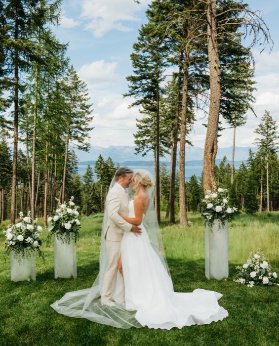 A couple beneath the ceremony arch